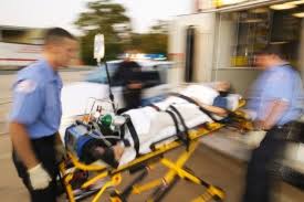 A person with a catastrophic injury is being loaded into an ambulance.